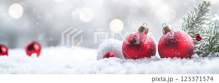 Panoramic snowy landscape with red Christmas ornaments, ideal for festive season marketing and greetings. 123371574