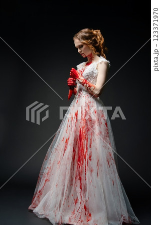 Bridal beauty in bloodied gown holding katana evokes dark fantasy Bridal beauty in bloodied gown holding katana evokes dark fantasy 123371970