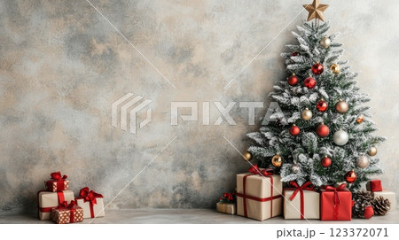 Beautiful Christmas tree with red and gold ornaments next to gifts wrapped in gold and red paper. A cozy Christmas scene perfect for holiday greetings 123372071