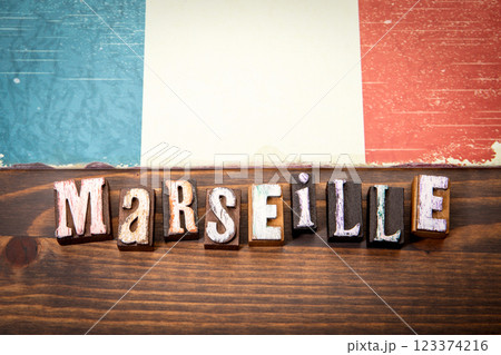 MARSEILLE. Flag and alphabet letters on wooden texture background MARSEILLE. Flag and alphabet letters on wooden texture background 123374216