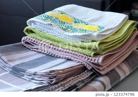Clean after washing waffle kitchen towels, flannel plaid linens. Stacked pillowcases, duvet cover after ironing. Cleanliness and housekeeping. Clean after washing waffle kitchen towels, flannel plaid linens. Stacked pillowcases, duvet cover after ironing. Cleanliness and housekeeping. 123374796