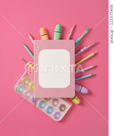 Composition of various art and drawing supplies in pastel colors on pink background. Space for your text. 123375408