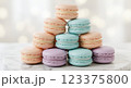 Elegant French macarons in pastel colors, stacked in a pyramid on a marble plate, with soft bokeh background, ultra-detailed, high-resolution close-up shot 123375800