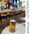 A glass of light beer is on the table 123375993