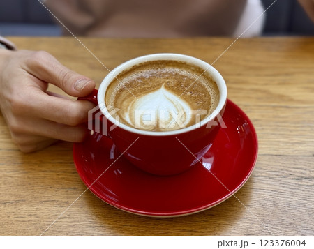 Red cappuccino cup with latte art 123376004