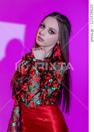 A Stylish Model Dressed in a Floral Outfit Featuring Bold and EyeCatching Colors 123376020