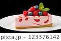 Delicious slice of strawberry cheesecake with fresh berries and mint leaves, placed on a white ceramic plate, soft shadows, professional studio lighting, ultra-sharp, close-up 123376142