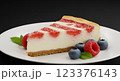 Delicious slice of strawberry cheesecake with fresh berries and mint leaves, placed on a white ceramic plate, soft shadows, professional studio lighting, ultra-sharp, close-up 123376143