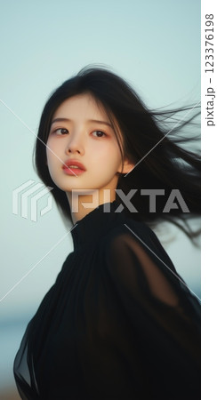 Ethereal Beauty Woman in Black Dress with Windswept Hair at Sunset ai generative ai generative 123376198