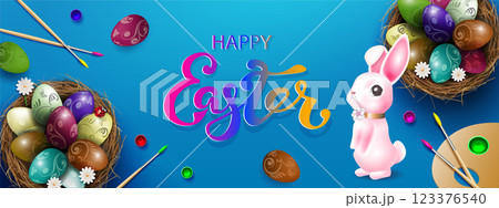 Composition with Easter eggs in a straw nest, a palette of paints and a cute rabbit 123376540