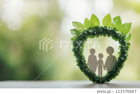 family silhouette surrounded by green leaf wreath symbolizes unity and eco friendliness. This conveys strong message about environmental awareness and family values 123376667