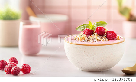 Delicious smoothie bowl topped with raspberries and granola 123376705