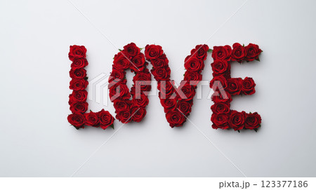 Red roses arranged to spell LOVE on white background, symbolizing romance and affection 123377186