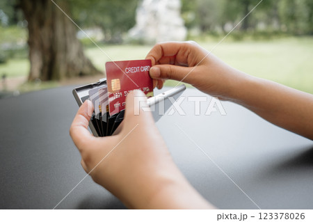 Close-up of woman's hand is taking out a credit card to pay at a cafe or restaurant. Close-up of woman's hand is taking out a credit card to pay at a cafe or restaurant. 123378026