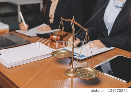 Attractive young lawyer in office Business woman and lawyers discussing contract papers with brass scale on wooden desk in office. Law, legal services, advice, Justice and real estate concept. Attractive young lawyer in office Business woman and lawyers discussing contract papers with brass scale on wooden desk in office. Law, legal services, advice, Justice and real estate concept. 123378242