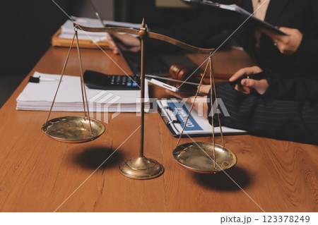 Attractive young lawyer in office Business woman and lawyers discussing contract papers with brass scale on wooden desk in office. Law, legal services, advice, Justice and real estate concept. Attractive young lawyer in office Business woman and lawyers discussing contract papers with brass scale on wooden desk in office. Law, legal services, advice, Justice and real estate concept. 123378249