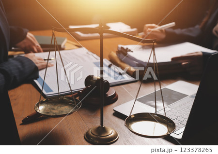Attractive young lawyer in office Business woman and lawyers discussing contract papers with brass scale on wooden desk in office. Law, legal services, advice, Justice and real estate concept. 123378265
