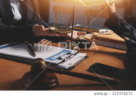 Attractive young lawyer in office Business woman and lawyers discussing contract papers with brass scale on wooden desk in office. Law, legal services, advice, Justice and real estate concept. Attractive young lawyer in office Business woman and lawyers discussing contract papers with brass scale on wooden desk in office. Law, legal services, advice, Justice and real estate concept. 123378272