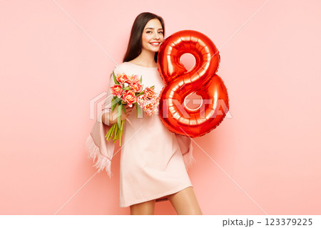 Woman hold bouquet of flowers and balloon number 8 123379225