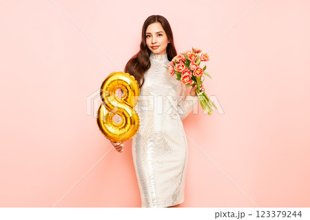 Woman hold bouquet of flowers and balloon number 8 123379244
