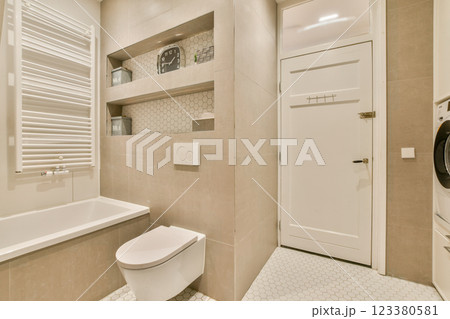 Elegant modern bathroom featuring a minimalist design with neutral tones, modern fixtures, and sleek lines, creating a stylish and functional space. 123380581