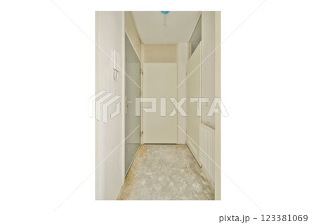 A spacious indoor hallway featuring a neutral color palette with white doors and walls, leading to closed doors, ideal for modern interior design. 123381069