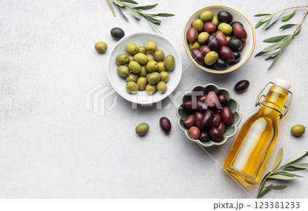 Assorted olives with olive oil and olive branches creating culinary delight 123381233