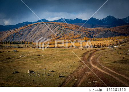 Serene rural landscape with rolling hills and distant mountain range 123381536