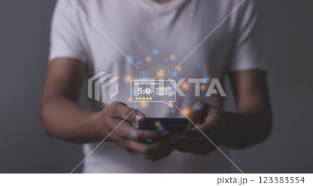 Young Man hand holding Smart Phone with five star to review and give 5 stars  123383554