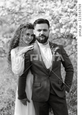 a bearded groom and a girl with green hair are walking 123383769