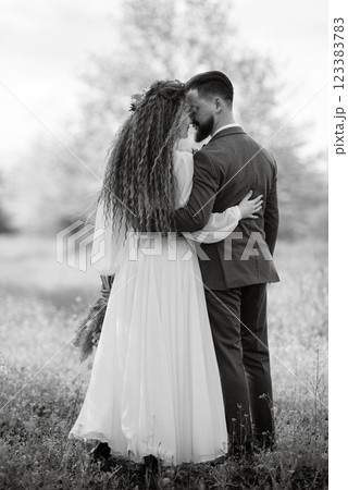a bearded groom and a girl with green hair are walking a bearded groom and a girl with green hair are walking 123383783