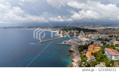 Aerial View Of Nice, France, Showcasing The Scenic Harbor, A Lighthouse, And The Expansive Mediterranean Coastline With A Vibrant Cityscape 123384211
