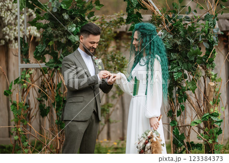 wedding ceremony of the newlyweds in a country cottage 123384373