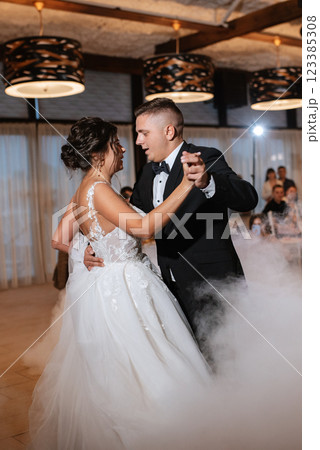the first dance of the bride and groom inside a restaurant the first dance of the bride and groom inside a restaurant 123385308