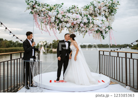 wedding ceremony of the newlyweds on the pier wedding ceremony of the newlyweds on the pier 123385363