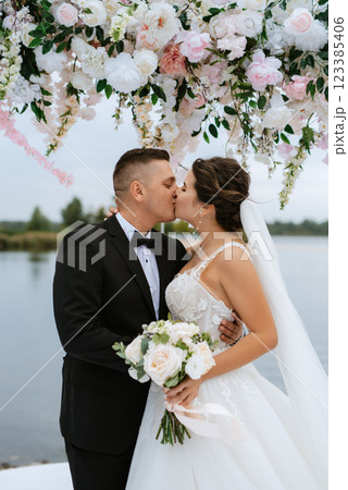 wedding ceremony of the newlyweds on the pier 123385406