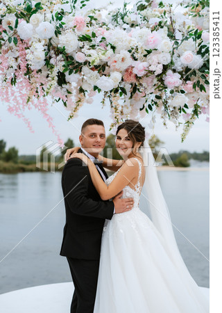 wedding ceremony of the newlyweds on the pier 123385411