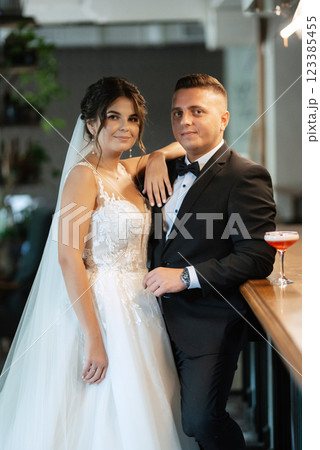 bride and groom inside a cocktail bar 123385455