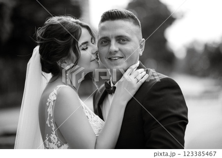 the groom in a brown suit and the bride in a white dress the groom in a brown suit and the bride in a white dress 123385467