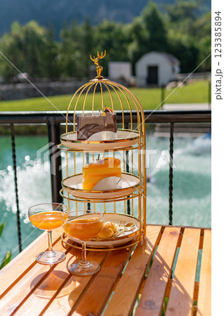 Afternoon tea set, orange juice, English style, dessert set, near the pool. Afternoon tea set, orange juice, English style, dessert set, near the pool. 123385894