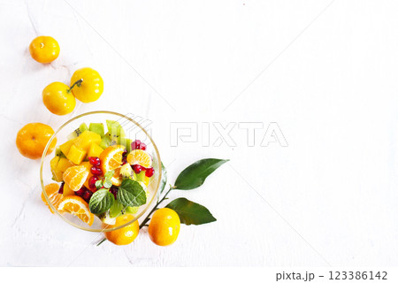 Sweet mandarins and green leaves on light background Sweet mandarins and green leaves on light background 123386142