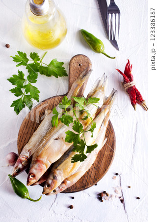 Fresh fish and spice on white table Fresh fish and spice on white table 123386187