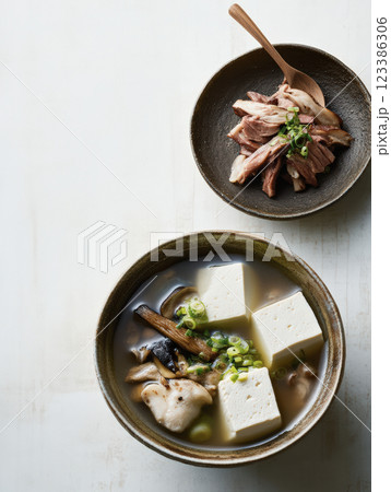Japanese tofu soup with mushrooms and scallions 123386306