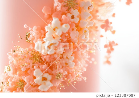 Elegant pink cake with gold popcorn decorations Elegant pink cake with gold popcorn decorations 123387087