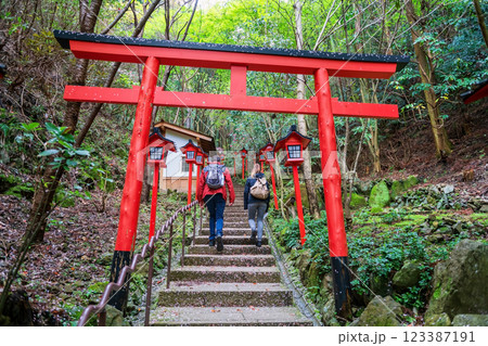 Tourist couple walk though torii gate at Nanzoin temple, Fukuoka Tourist couple walk though torii gate at Nanzoin temple, Fukuoka 123387191