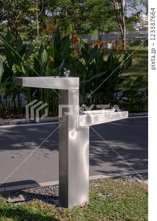Outdoor drinking fountain. Public fountain that provide free drinking water for peoplein city park. 123387664