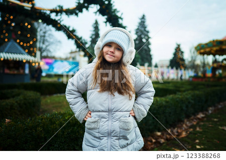 Smiling child enjoying winter festivities at an outdoor park Smiling child enjoying winter festivities at an outdoor park 123388268