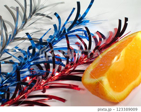 A slice of orange and festive decoration background 123389009
