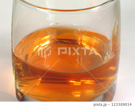 Glass of whiskey on white background Glass of whiskey on white background 123389014