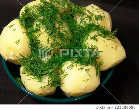 Boiled potatoes with greens decoration close view background Boiled potatoes with greens decoration close view background 123389085